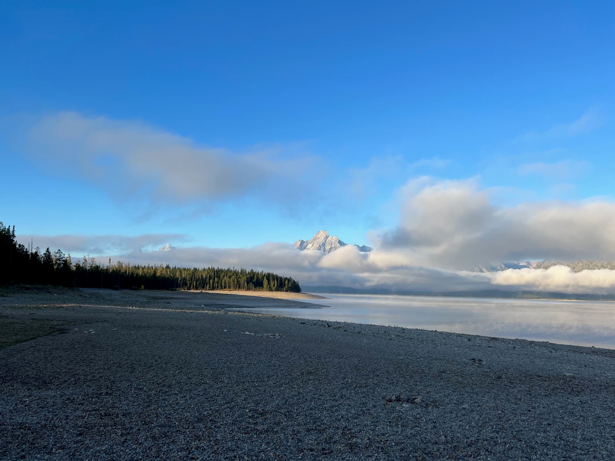 Iceberg floating in a calm fjord with still water reflections