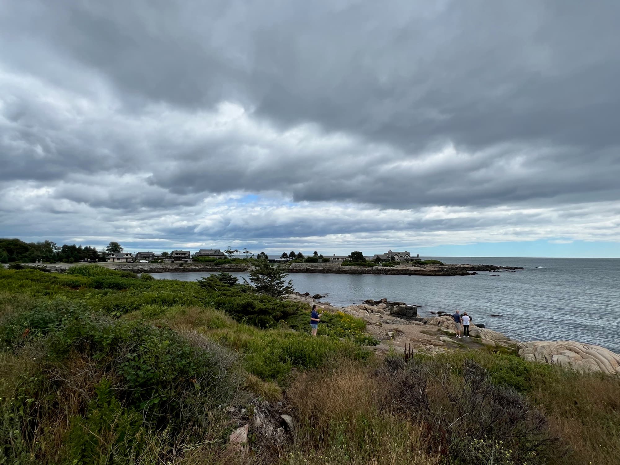 Kayaking through coastal waters along a rocky shore