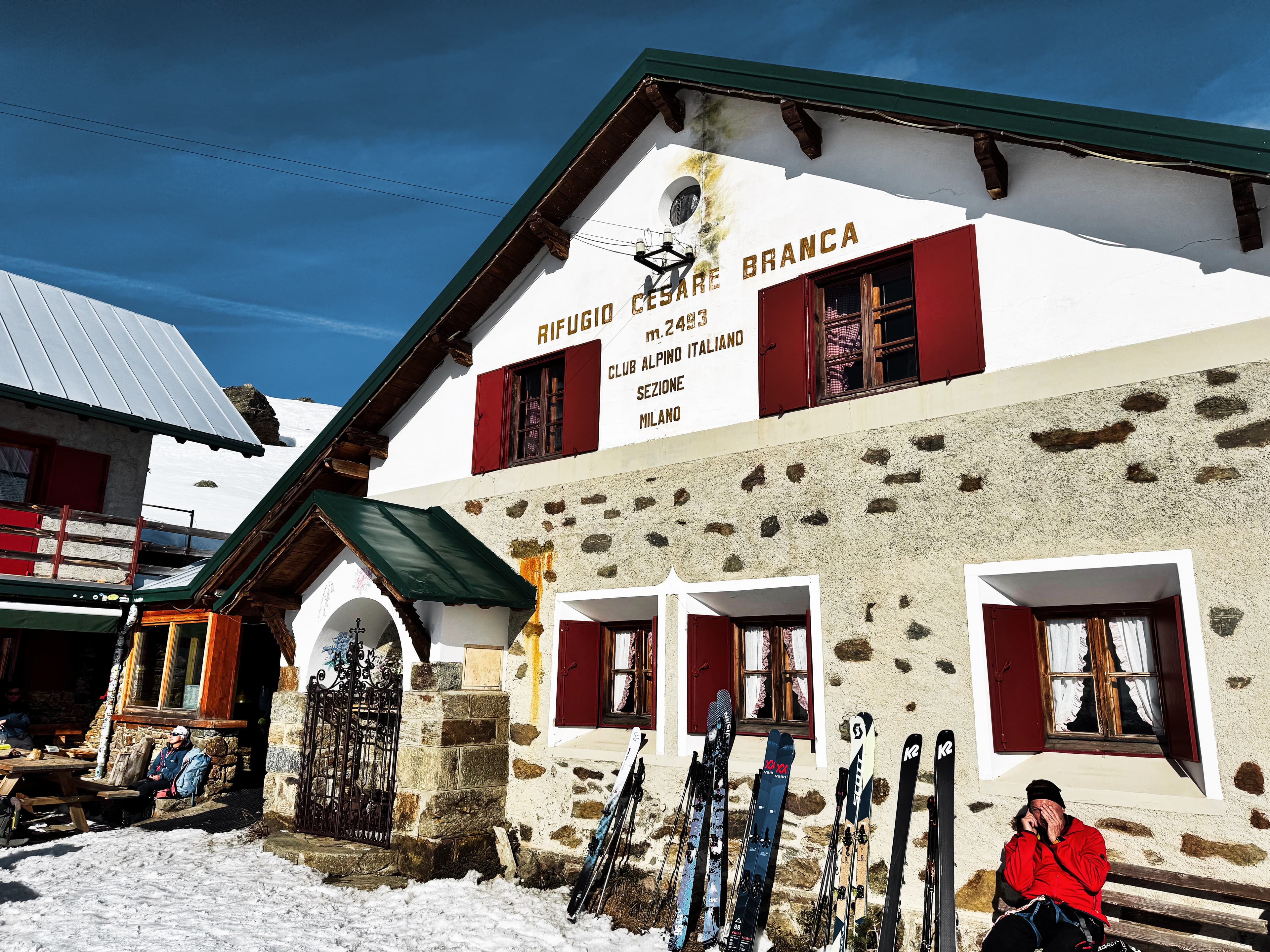Rifugio Cesare Branca at 2493m with skis lined up outside